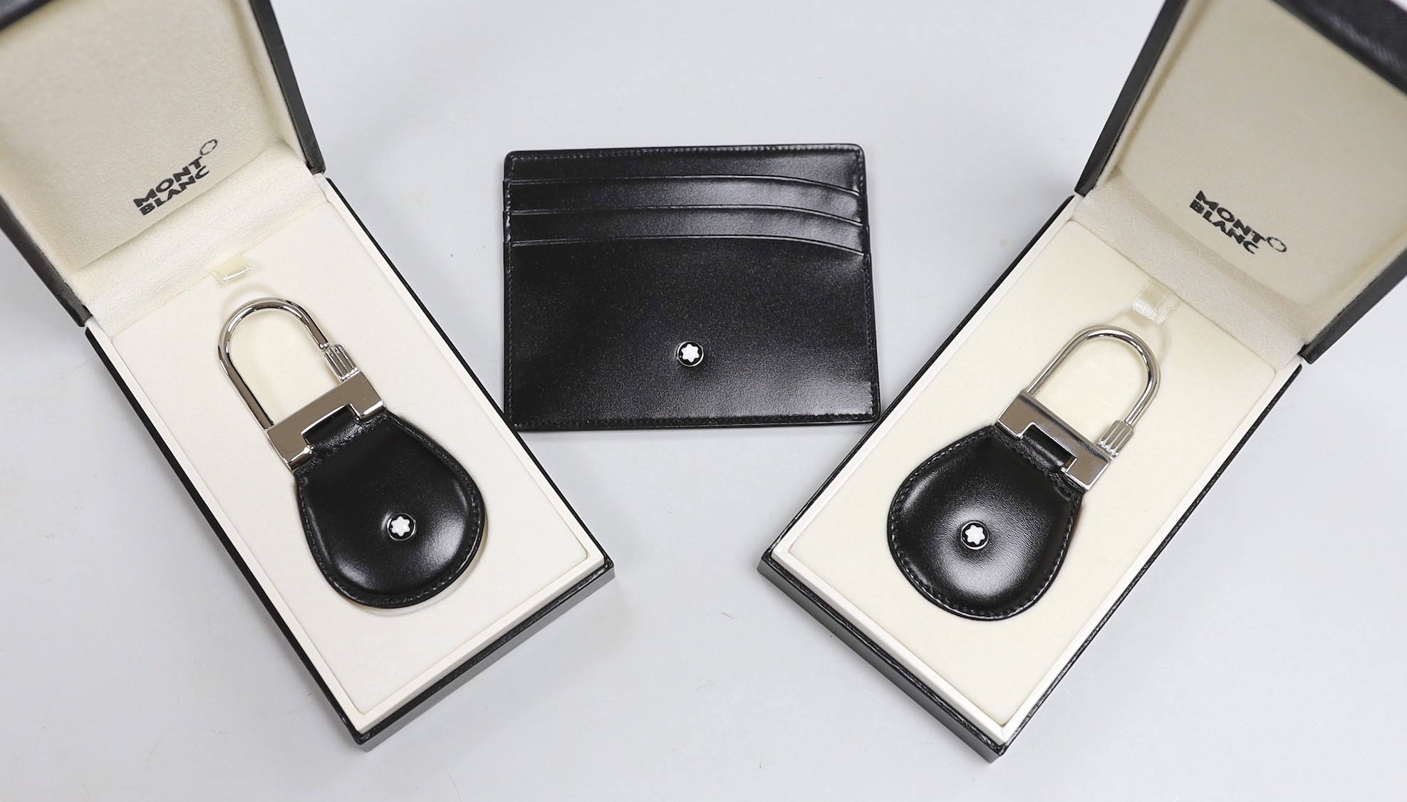 A Mont Blanc Meisterstuck credit card holder (new), a Mont Blanc Porte Cles key fob (new, full certification) and a Mont Blanc Porte Cles key fob (new, fill certification)